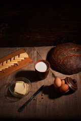 Assorted dairy products milk, cheese, butter rustic still life on table