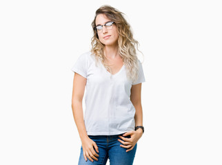Fototapeta premium Beautiful young blonde woman wearing glasses over isolated background winking looking at the camera with sexy expression, cheerful and happy face.