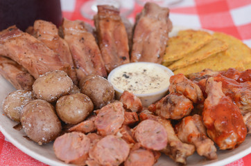 Grilled meat dish with nachos and sauce.