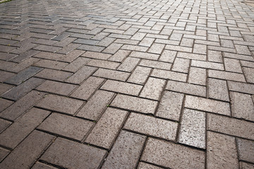 Texture of road tiles with herringbone pattern. Perspective view