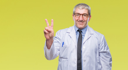 Handsome senior doctor, scientist professional man wearing white coat over isolated background...