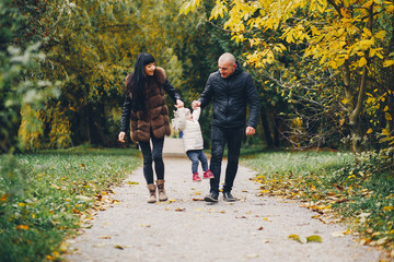 Obraz premium Cute family walking in a autumn park. Mother with little daughter