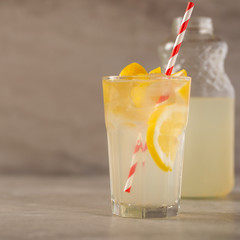 Cocktail with lemonade with lemon and lime, cold refreshing drink or drink with ice