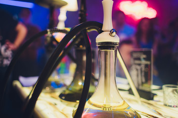 empty glass hookahs under the light of neon against the background of the restaurant. beautiful...