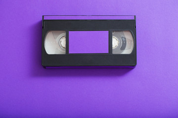 Obraz premium Video cassette on violet background.