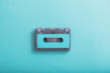 Fototapeta premium Old plastic cassette on green background. Retro music concept