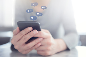 Hand using smart phone with Social media, social network concept, copy space.