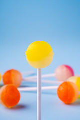 Selective focus lollipop candy on blue background