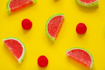 Fruit jelly segments in the form of watermelon on yellow