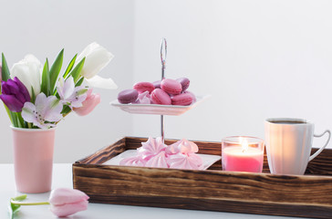  Tulips in vase and cup of coffee with dessert on white backgrou