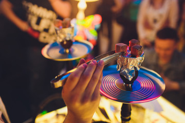 Shisha hookah with red hot coals. Sparks from breathe. Modern hookah with coconut charcoal for...