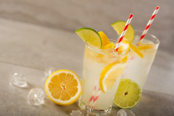 Lemonade. Drink with fresh lemons and limes. Summer mood, Lemon cocktail with juice and ice.