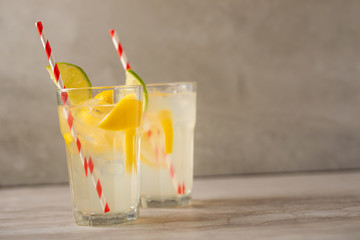 Lemonade. Drink with fresh lemons and limes. Summer mood, Lemon cocktail with juice and ice. Refreshing drink