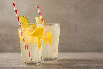 Cocktail with lemonade with lemon and lime, cold refreshing drink or drink with ice