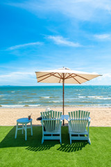 lounge chairs with sun umbrella on a beach