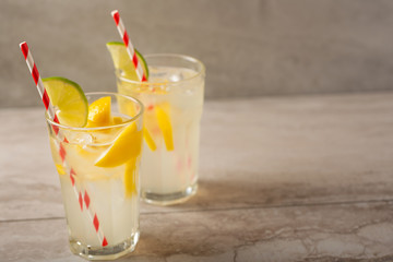 Cocktail with lemonade with lemon and lime, cold refreshing drink or drink with ice
