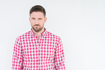 Young handsome man wearing shirt over isolated background skeptic and nervous, frowning upset...