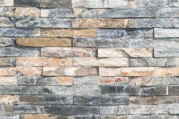 brick wall , texture of multi colored stone blocks closeup