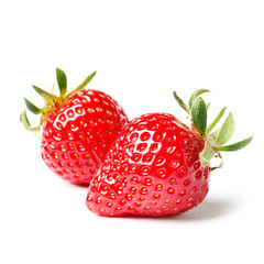 Two strawberries close up on white background