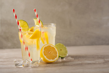 Lemonade. Drink with fresh lemons and limes. Summer mood, Lemon cocktail with juice and ice.