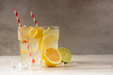 Lemonade. Drink with fresh lemons and limes. Summer mood, Lemon cocktail with juice and ice.