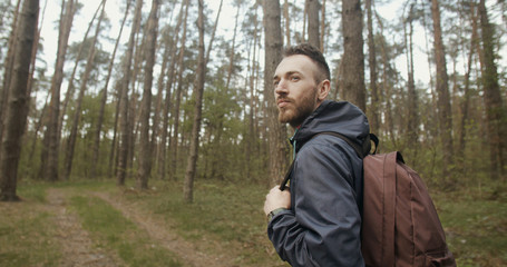 Handsome young traveler man in the forest
