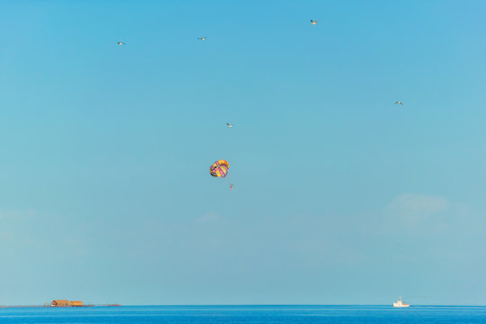 Flight on a parachute behind a boat on lake Issyk Kul. Extreme form of recreation. Rest in Kyrgyzstan.