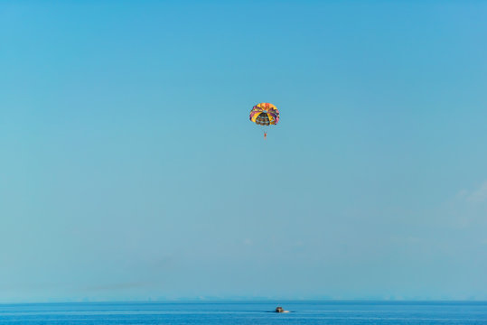 Flight on a parachute behind a boat on lake Issyk Kul. Extreme form of recreation. Rest in Kyrgyzstan.
