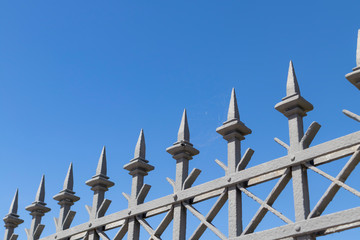 Patterned metal fence with peaks around the perimeter of the old prison