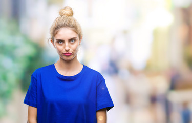 Young beautiful blonde and blue eyes woman wearing blue t-shirt over isolated background depressed and worry for distress, crying angry and afraid. Sad expression.
