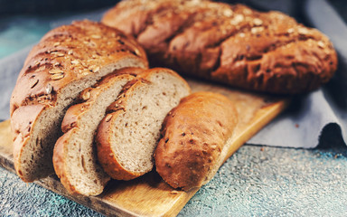 Bread with cereals on a wooden cutting board.