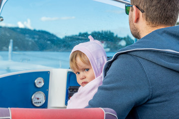 Little girl with dad on the boat