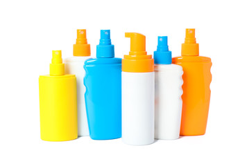Many different sunscreen sprays isolated on white background. Summer vacation accessories