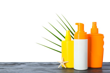 Sunscreen sprays with starfish and palm leaf on wooden table isolated on white background. Safe tan accessories