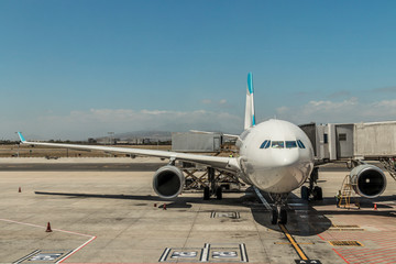 Airplane at the airport in South Africa. Landing and exit of the passengers. Flights and planes in...