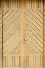 vintage wooden door with shutters on a red brick wall. Vertical old door