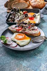 Tasty breakfast. Eggs, sandwich, cheese, vegetables, mushrooms and herbs.
