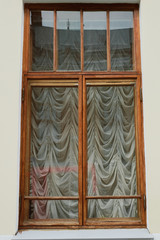old window with curtains outside. Wooden single window
