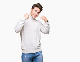 Fototapeta premium Young handsome man wearing turtleneck sweater over isolated background looking confident with smile on face, pointing oneself with fingers proud and happy.