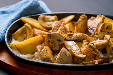 pan with potatoes, meat and mushrooms, baked in the oven