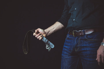 Strict man with belt. BDSM concept.