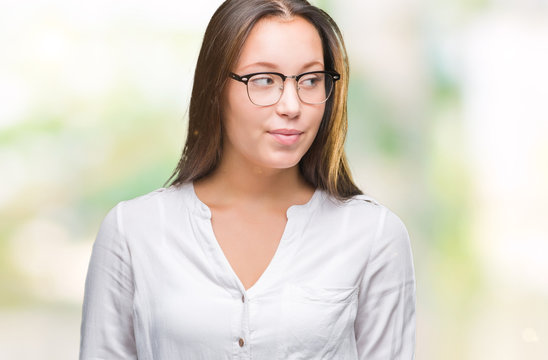 Young caucasian beautiful business woman wearing glasses over isolated background smiling looking side and staring away thinking.