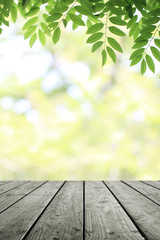 Naklejka na ściany i meble Wooden table and blurred green nature garden background.