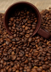 Coffee cup and coffee beans. Can be used as a background.