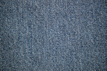 Close up background image of old indigo blue cotton denim jean fabric.