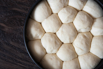 Raw unbaked buns in the pan. Ready to bake homemade buns