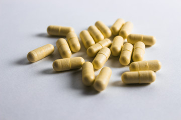 Pills on white background. Medical care and treatment. Medicine and pills, medications on white background. Yellow  drugs.