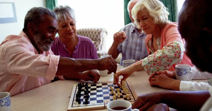 Active diverse senior people playing chess game in the nursing home 4k