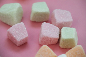 Colorful marshmallows on pink background