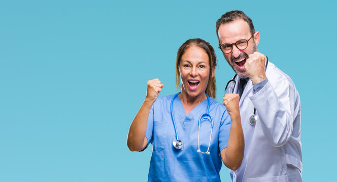 Middle Age Hispanic Doctors Partners Couple Wearing Medical Uniform Over Isolated Background Celebrating Surprised And Amazed For Success With Arms Raised And Open Eyes. Winner Concept.